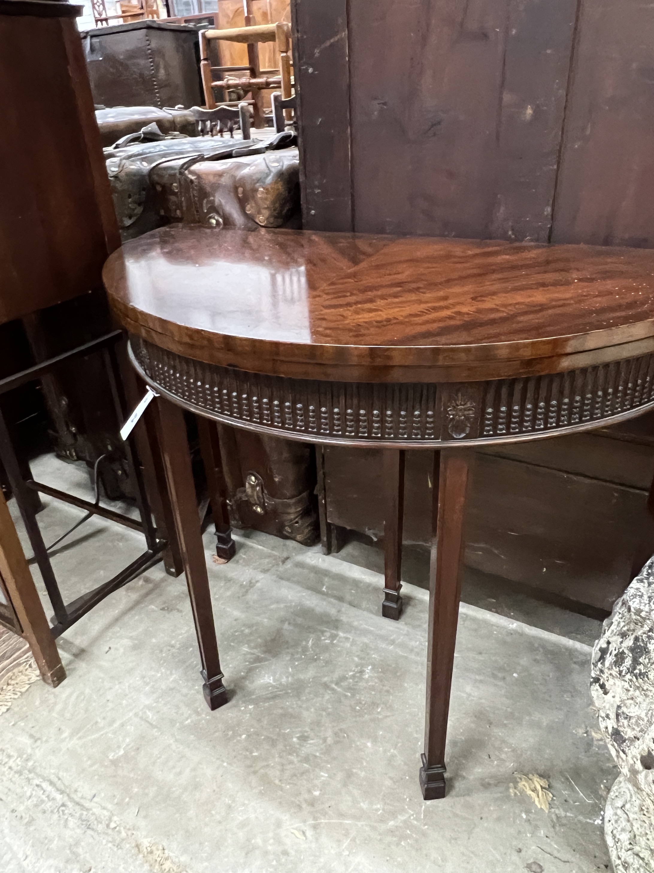 A Chippendale revival mahogany demi lune folding card table, width 92cm, depth 46cm, height 77cm